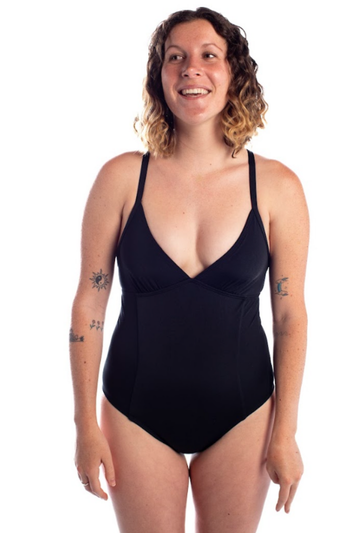 Woman wearing a black swimsuit on a white background